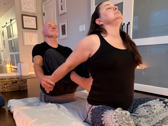 H3 Assisted stretching, instructor helping with pose