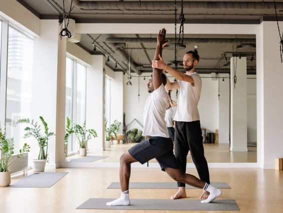 P5 Yoga instructor helping with a pose